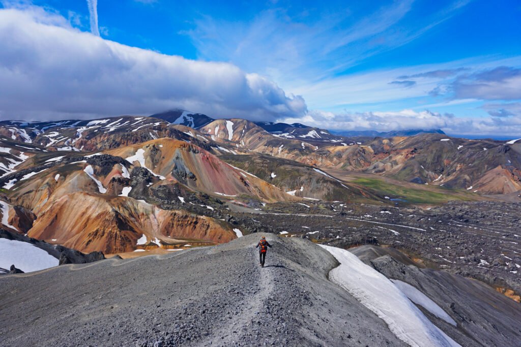 A man is walking on the ridge of Landmannalaugar, laugavegurinn trail