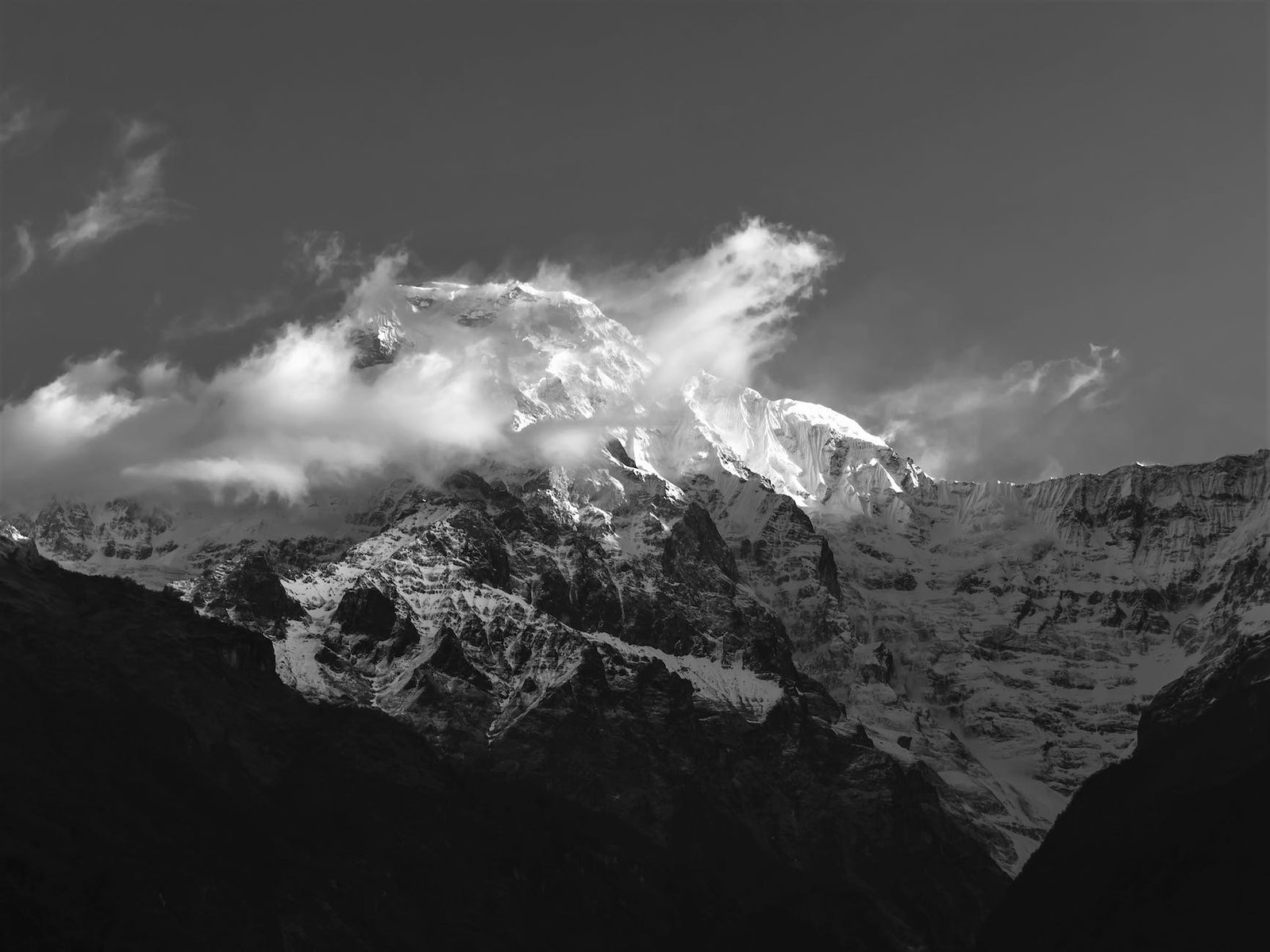 grayscale photo of a snow capped mountain